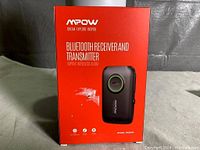 Front view of boxed MPOW Bluetooth Receiver and Transmitter showing product branding and model number BH390A