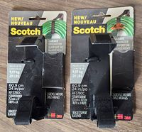 Front view of two new Scotch Garage Organizer Bracket and Strap packages, black, each holding up to 20 lbs, model RF3780C, sealed packaging