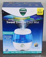 Box of Vicks Sweet Dreams Cool Mist Humidifier showing branding, product name, and key features including filter free, 24 hour runtime, 3.8 L water capacity, and bedtime theme projections.