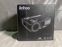 Black box of Jinhoo mini projector with product illustration and branding