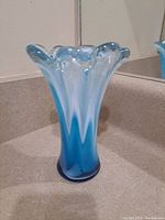 Side view of the blue and white blown glass vase