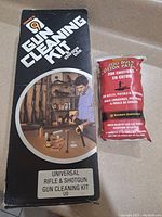 Closed box of Hoppe's 9 Universal Rifle & Shotgun Gun Cleaning Kit with a sealed bag of 200 cotton cleaning patches displayed beside it.