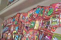 Image showing a wide spread of red bordered Trash Pack trading cards featuring various colorful characters with worn edges and corners.