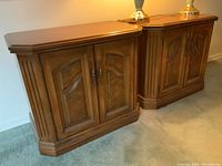 Pair of Kroehler wood and veneer night tables with beveled tops, carved detail on doors, and brass pulls