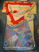 Two handmade quilts and one small cushion arranged together, shows overall condition and size comparison.