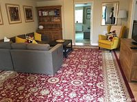 Rug under living room furniture showing floral pattern and overall color scheme
