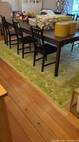 Full view of rug under dining table showing overall size, color and pattern.