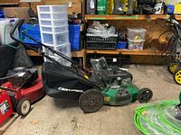 Side view of the mower showing deck, grass bagger and handle assembly