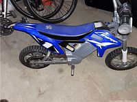 Side angle photo of blue Hyper mini dirt bike showing overall condition and design details.