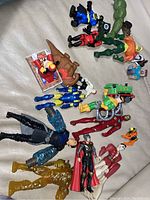 Lot of various superhero and character action figures including Thor, Hulk, Batman, and other assorted figures, along with a wooden Thomas & Friends train and a carded Talkboy figure.