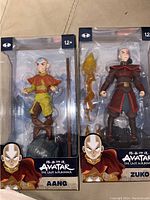 Two sealed Avatar: The Last Airbender action figures in packaging, featuring Aang and Zuko.