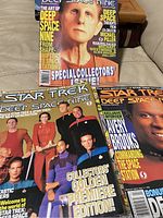 Photo showing three Star Trek Deep Space Nine magazines with covers featuring cast members including Avery Brooks and thematic content about the show.