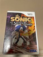 Front cover of the Sonic and the Secret Rings Wii game case showing game title, Sonic character, Wii and SEGA logos.