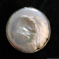 Close-up image of the pearl on the sterling silver ring showing surface texture and luster