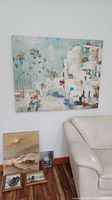 Overall view of large abstract canvas on wall with smaller paintings on floor