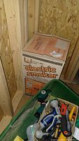 Photo of the boxed Little Chief electric smoker showing the front and top of the box in storage.
