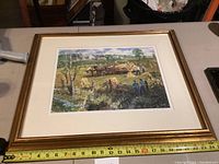 Framed print showing a wide rural farming scene with horses and people working in a field