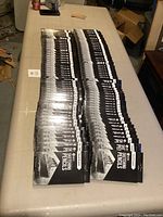 Overhead view of dozens of boxed pencil sets arranged on folding table