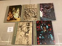 Five collectible art and history books arranged on the floor with various classical and Renaissance-themed cover art.