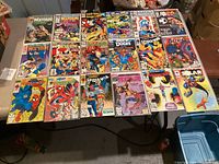 Photo showing 21 Marvel comic books arranged on a table, including multiple Wolverine, Spider-Man, and What If titles, among others.