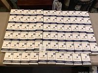 Seventy boxes of Pencil Buddies golf pencils arranged on a table showing quantity and packaging.