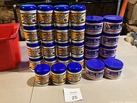 Overview of 19 yellow-labeled Mane 'n Tail jars on left and 10 blue-labeled Hollywood Beauty Cocoa Butter jars on right