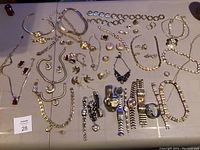 Full view of all jewelry pieces and watches laid out on table