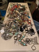 Overview of mixed jewelry pieces spread across a table
