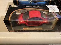 Red Volkswagen New Beetle Maisto Special Edition model car in box, 1:18 scale