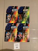 Front view of four Star Wars The Power of the Force action figures in original packaging featuring Luke Skywalker (two versions), a tan outfit character, and C-3PO.