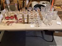 Wide view of the entire vintage crystal and glassware set displayed on a table.