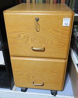 Front view of the 2-drawer wood filing cabinet with wood grain finish and metal handles, showing lock on top drawer.