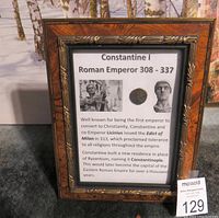 Framed display with text describing Constantine I, Roman Emperor 308 - 337, showing coin mounted on card and historical bust images