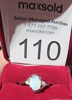 Ring in red velvet box showing opal and accent stones