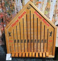 Full view of vintage wooden Horse Races board game with lanes, scores, and starting gates.