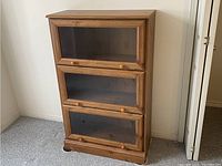 Frontal view of closed three-tier bookcase showing full exterior and finish