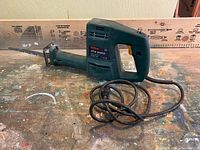 Side view of the Bosch PFZ 550 E reciprocating saw showing the blade, housing, and power cord on a workbench.