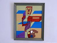 Full view of abstract painting with geometric human figure and colorful blocks, framed.