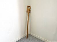 Full view of the entire wooden cane showing the length and straight shaft.