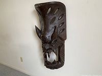 Mask angled view showing carved horns and side cutouts