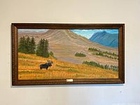 Frontal view of the large framed landscape painting featuring a moose and mountains