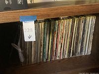 Shelf of vinyl LP records arranged vertically, spines facing out.