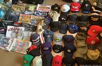 Top-down view of men's printed t-shirts, showing various graphic prints related to sports, racing, travel, and locations like Arizona and California.