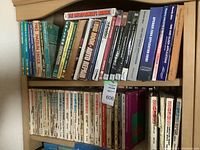Bookshelf showing a variety of automotive repair manuals including Chilton and Haynes