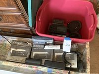 Multiple Crown Japan stereo car cassette players with radios in original packaging, along with some black car audio components and a coiled microphone in a drawer.