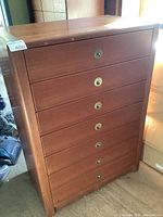 Front view of dresser showing six drawers with brass ring pull hardware