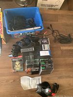 Multiple Sony PlayStation 2 controllers, cables, game discs in jewel cases including StarCraft, and a black/red digital joystick with manual