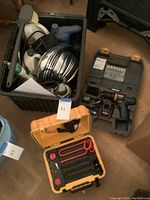 Ryobi electric drill in original black molded plastic carrying case with drill bits and accessories.