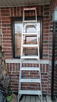 Front view of an 8-foot aluminum step ladder showing the overall structure and rung spacing.