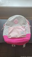 Front view of medium size Herschel kids backpack with light grey, pink, and pale pink color blocks.